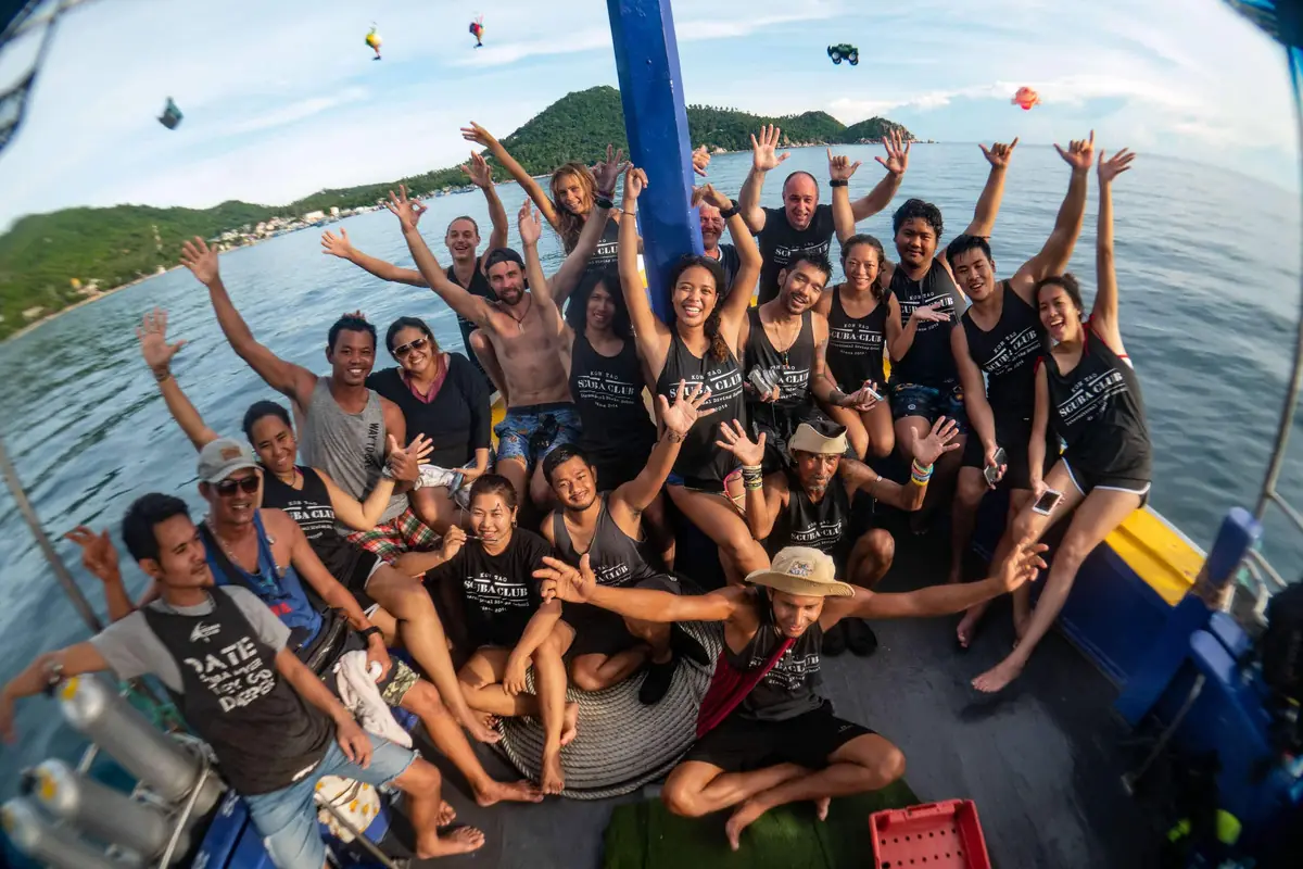 Divers celebrating together on the boat deck